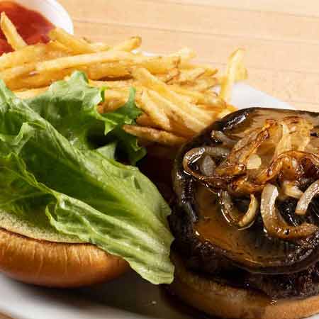 Portabella Hamburger - One handmade hamburger patty served with a portabella mushroom, grilled onions, lettuce, and portabella sauce.